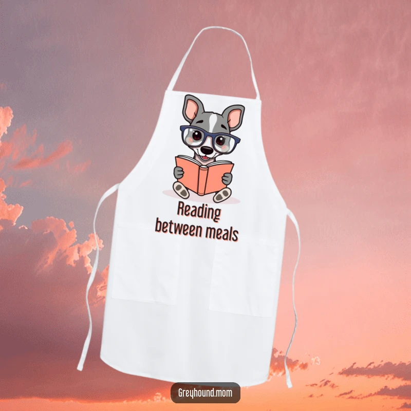 Funny Greyhound wearing reading glasses, enthusiastically reading a book, on a kitchen apron for a humorous and literary cooking experience.