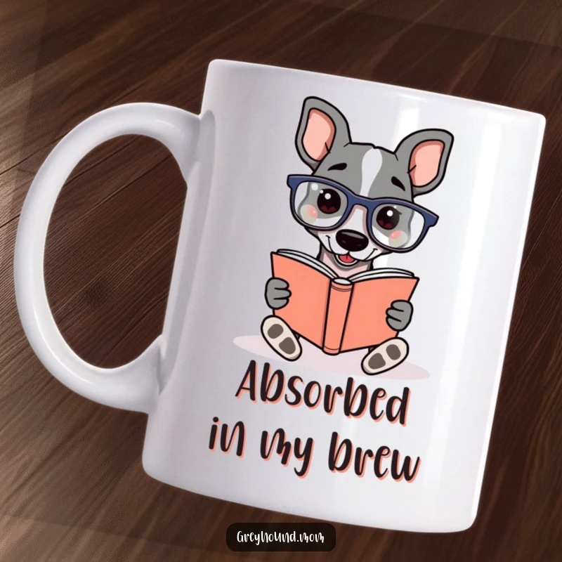 Funny Greyhound wearing reading glasses, enthusiastically reading a book, detailed on a mug for literary dog lovers.
