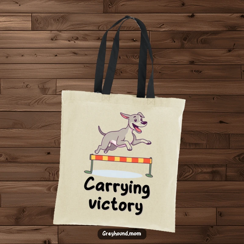 Funny Greyhound tote bag, a happy dog leaping joyfully over a small hurdle, perfect for carrying active essentials.